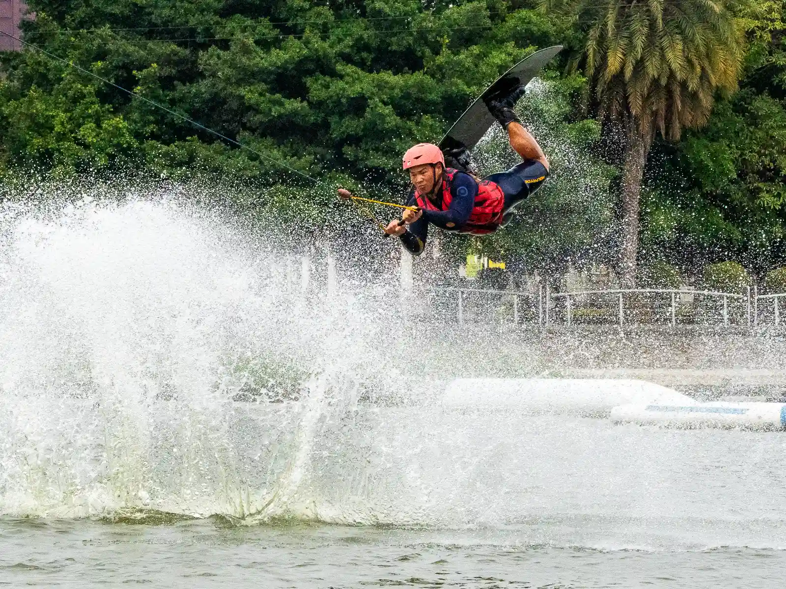 A wakeboarder flies through the air after performing a jump at Lotus Wake Park.