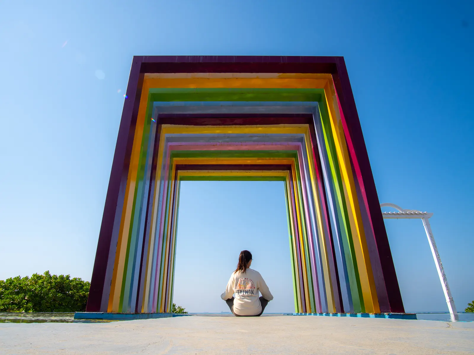 A low-angle photo of someone sitting beneath the Rainbow Church.