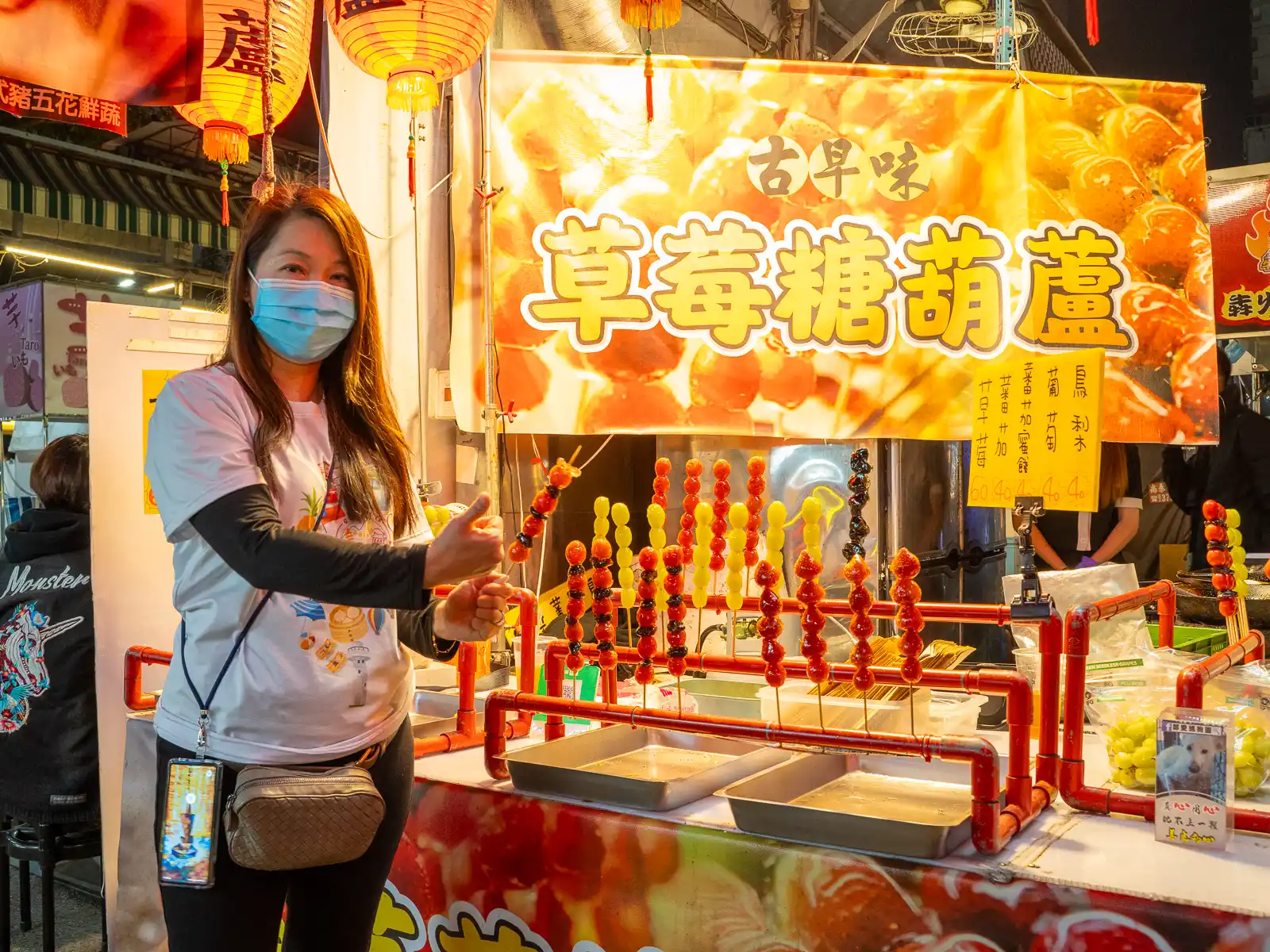 Glazed fruit skewers known as "Tanghulu" are on display at a street vendor.