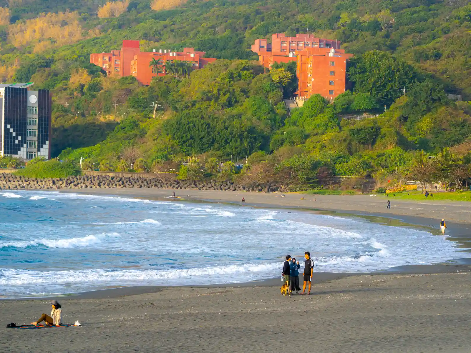 People relax on a quiet sandy beach.