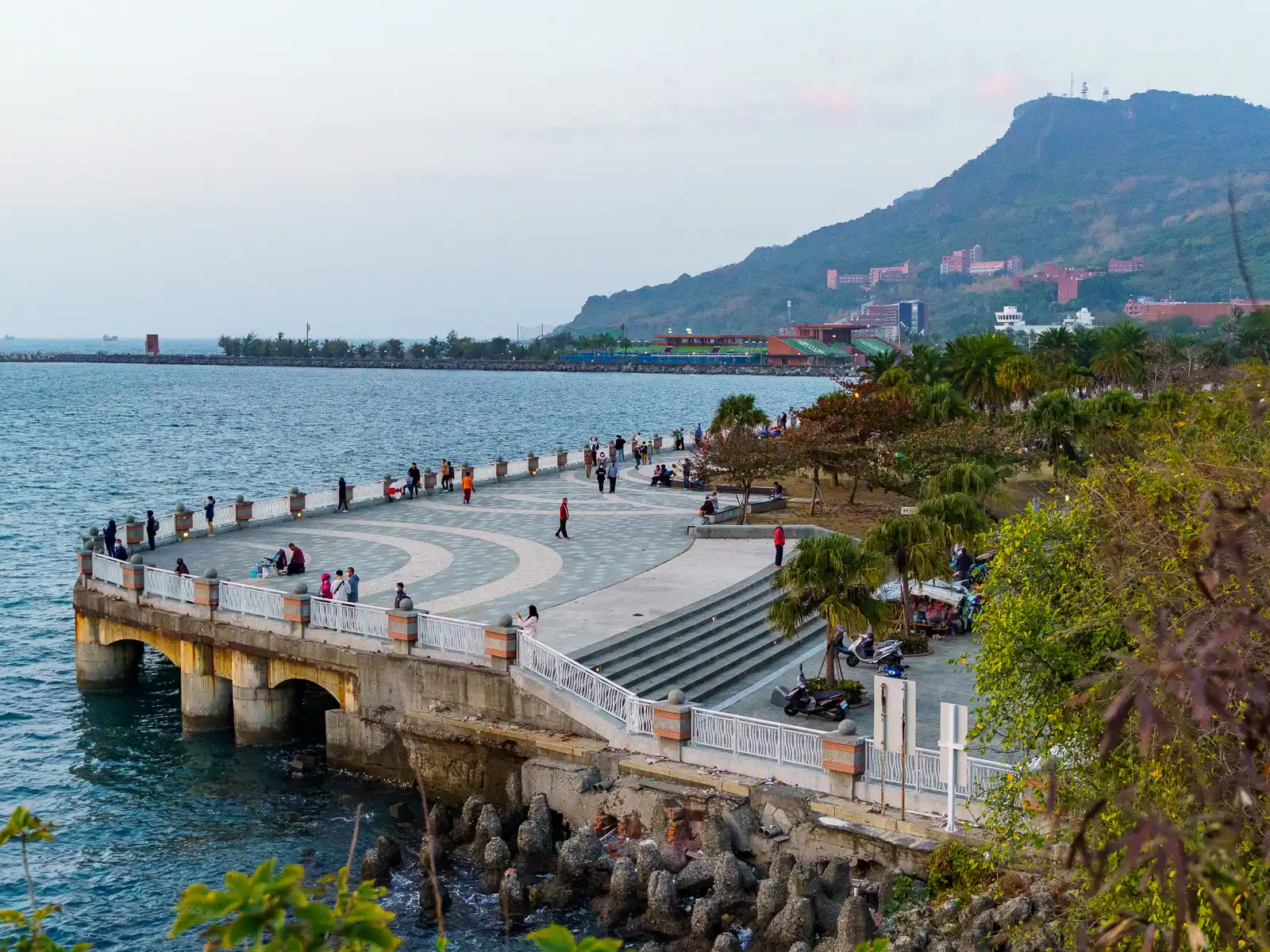 A wide boardwalk extends to meet the ocean at Sizihwan Lookout.