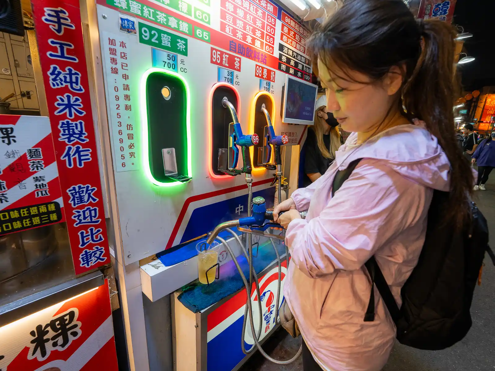 A self-serve refreshment dispenser in the form of a fuel pump in Feng Chia Night Market.