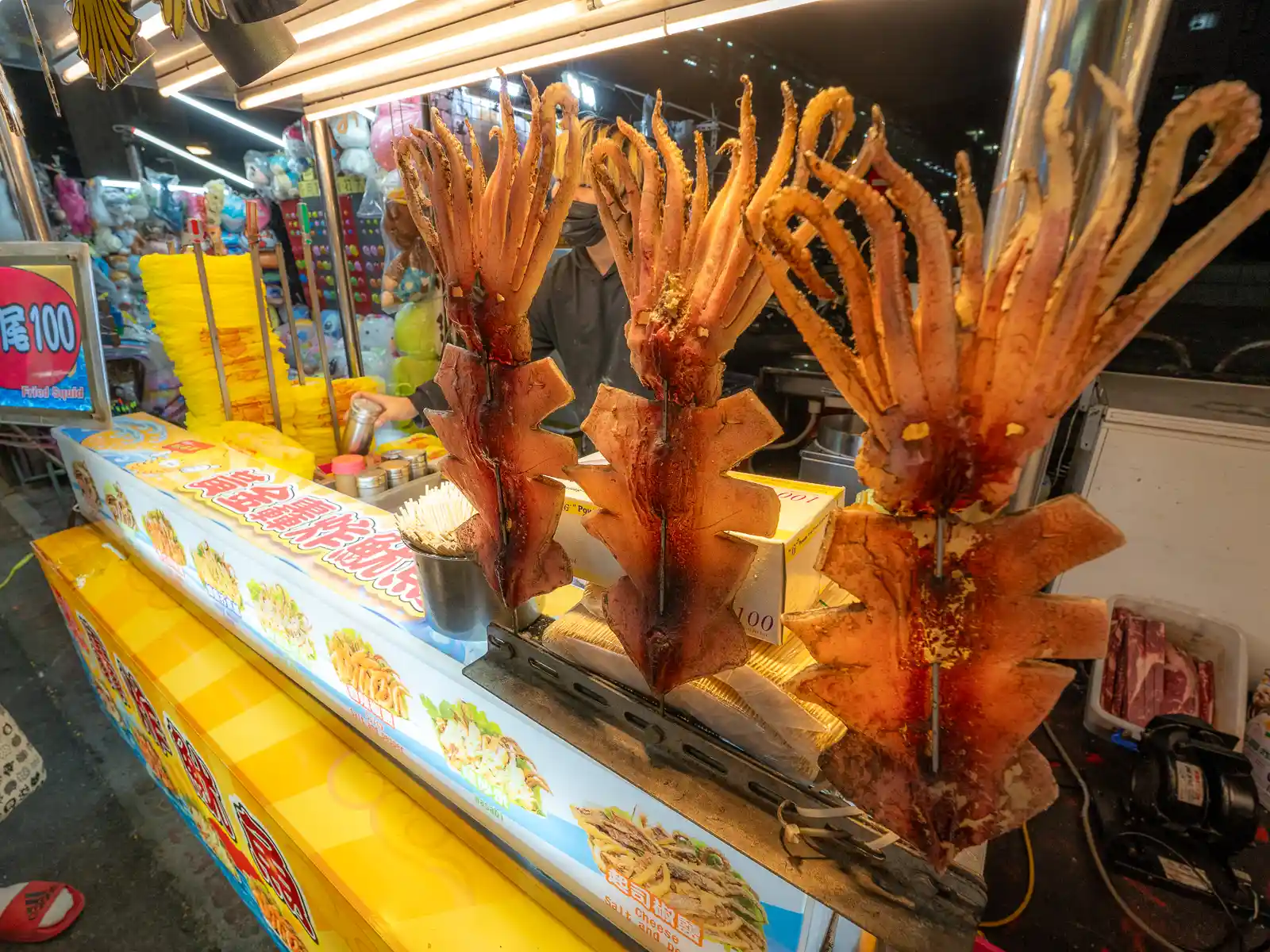 Squid are on display in a night market stand.