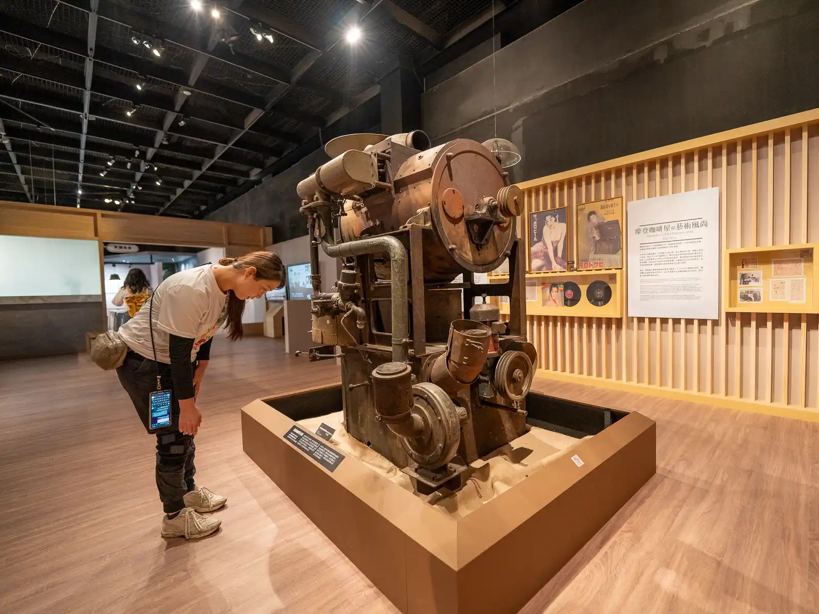 An extremely old and rusted coffee roasting machine is on display.