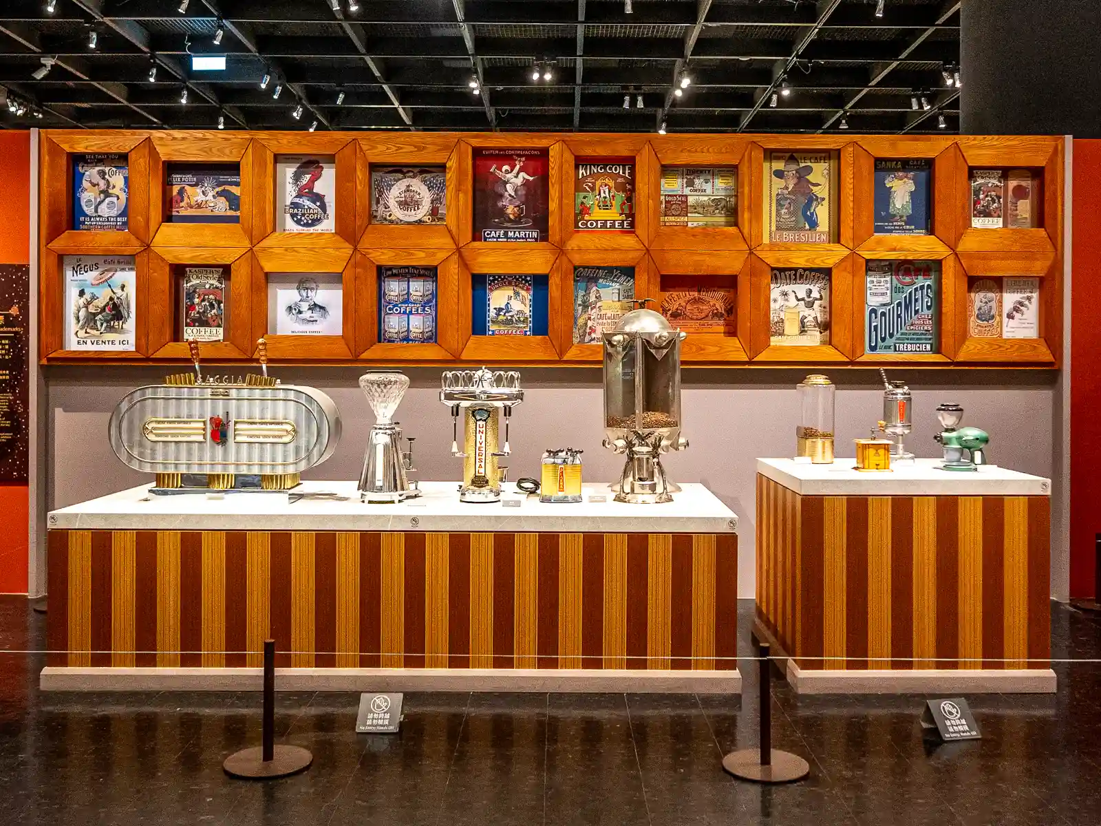 A row of beautiful vintage coffee machines is on display.