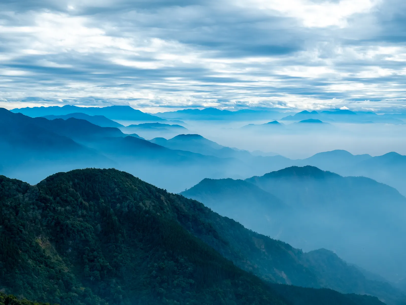 Rows of mountain ranges are visible from the top of Mt. Yuanzui.