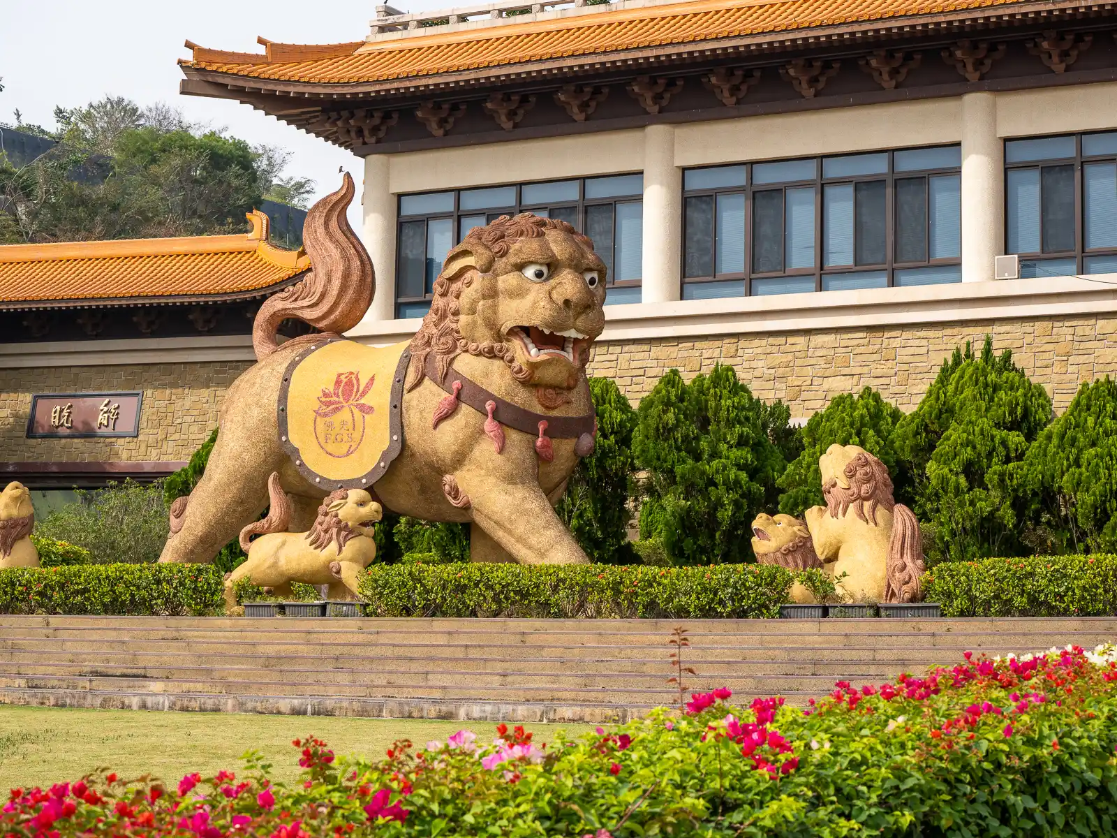 A statue of a magnificent lion surrounded by their cubs stands to the left of the entrance to the Front Hall.