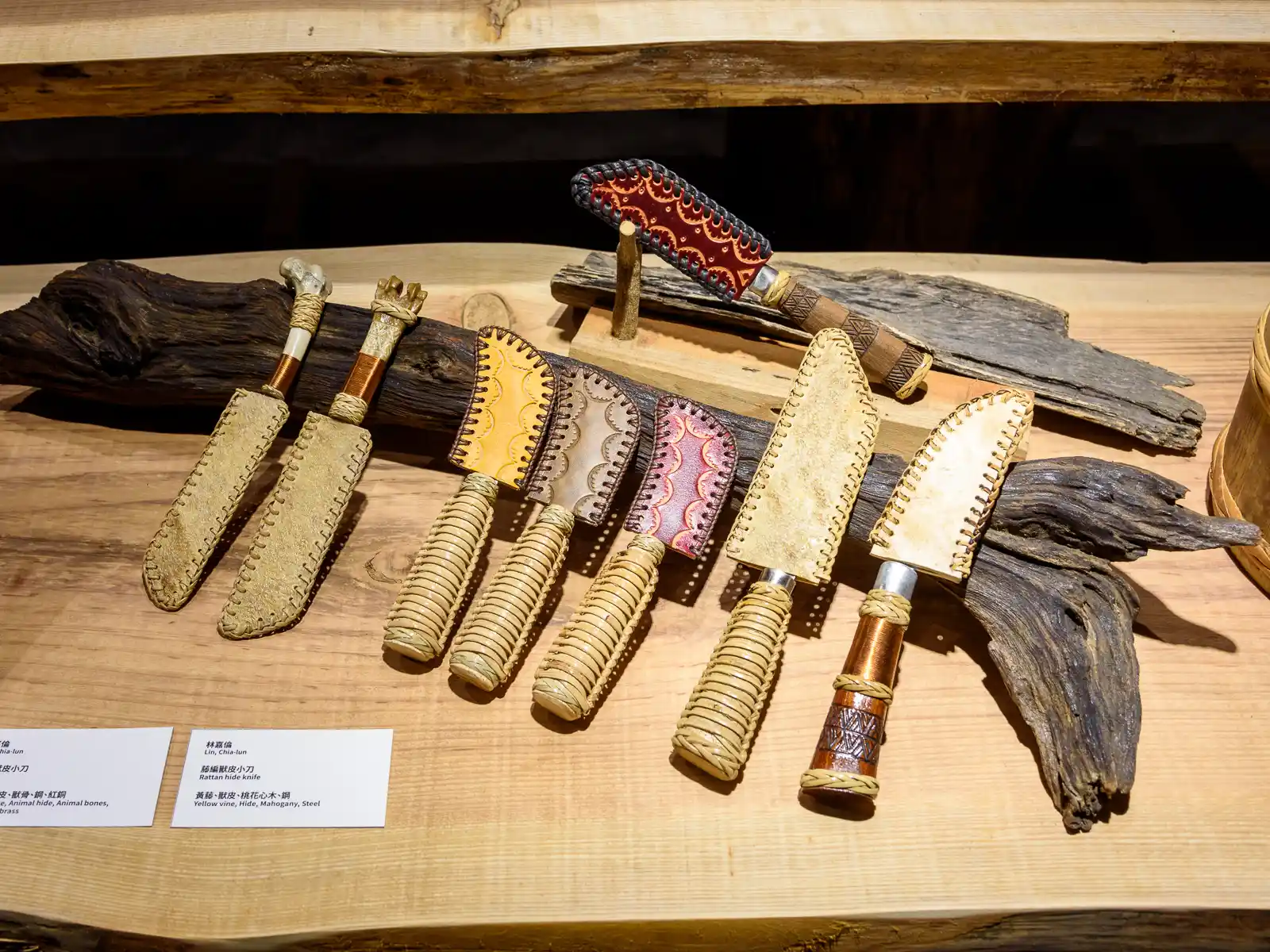 A row of hand-made knives is on display.