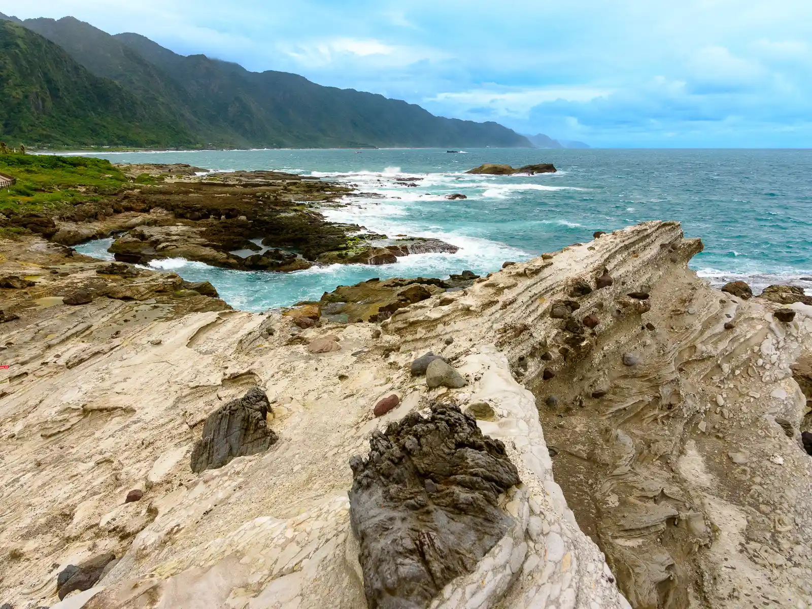 A ridgeline of the coastal mountains follows the shoreline all the way to the horizon.