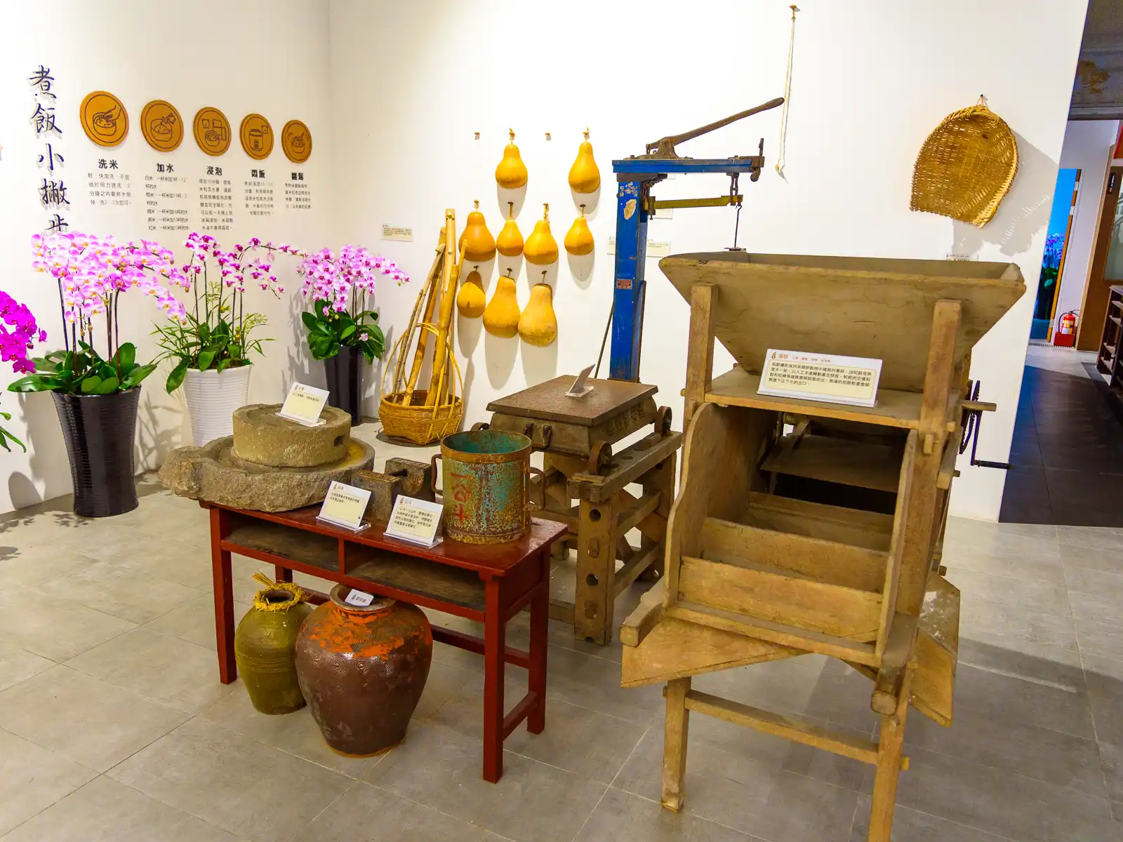 Stone and wooden tools used for the milling and husking of rice are on display.