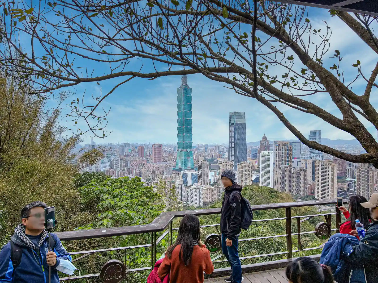 Tourists taking photos on a wooden overlook.