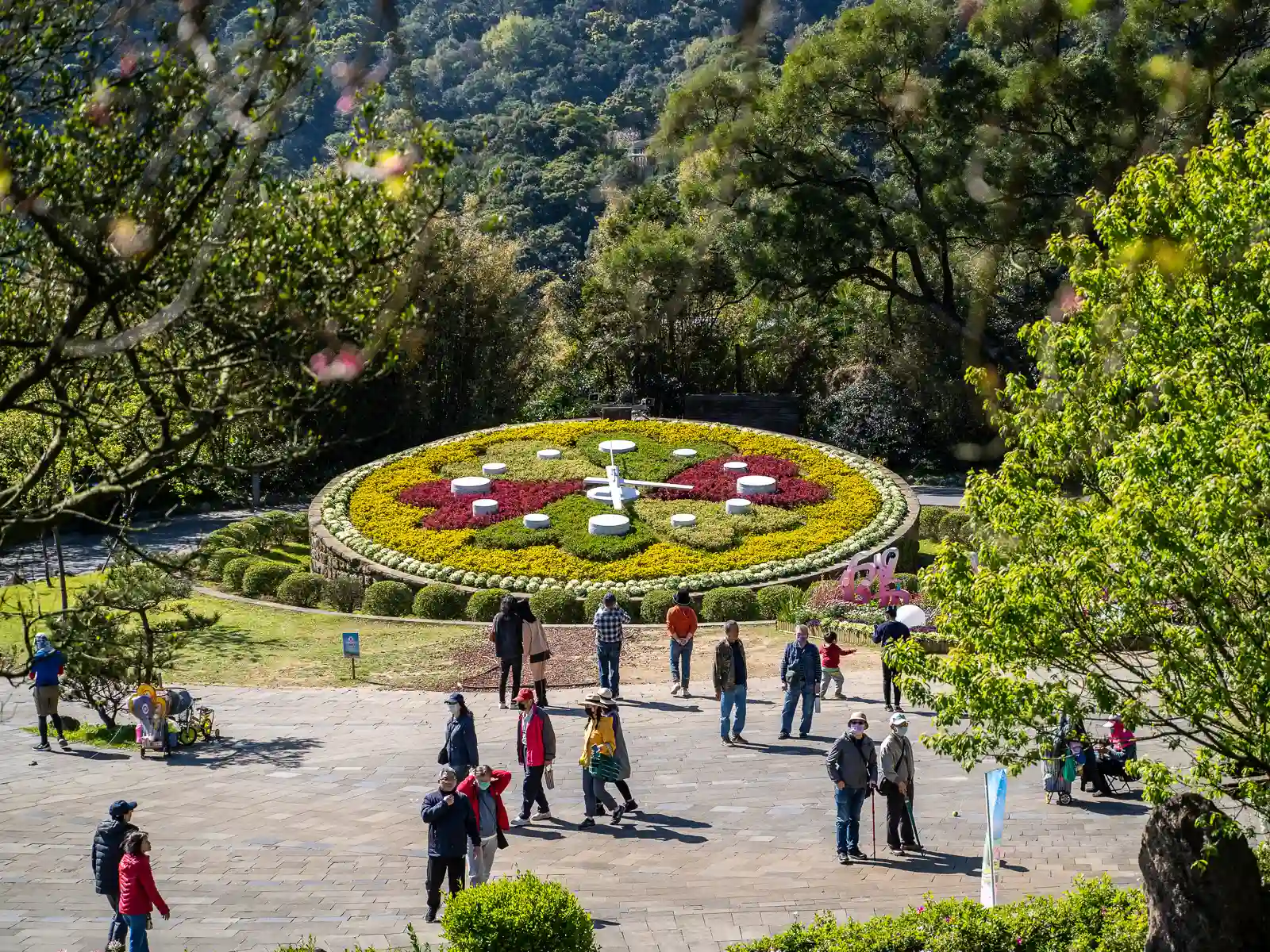 A giant, sloped clock is decorated with a variety of flower patches.