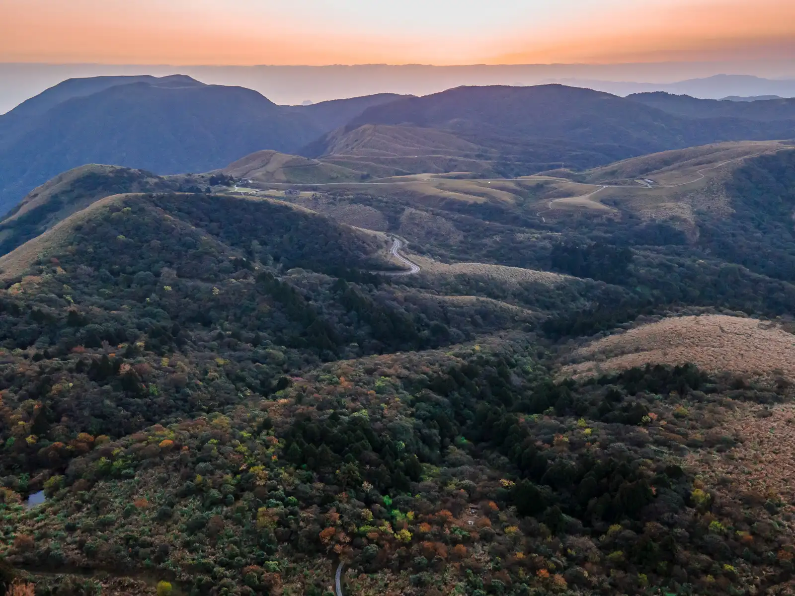 Roads and paths wind through a grassy, hilly landscape on top of Yangmingshan National Park.