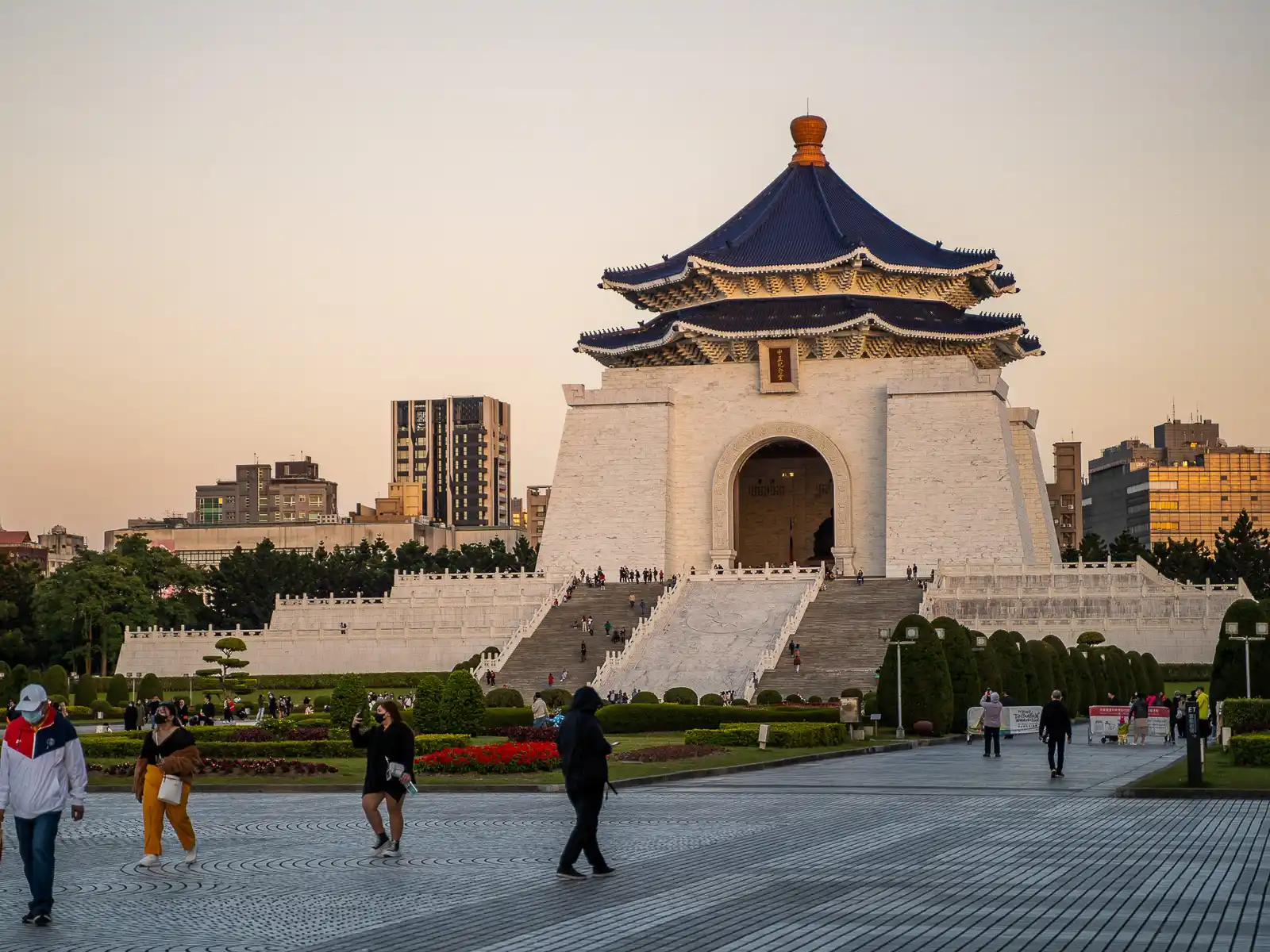 Chiang Kai Shek Memorial Hall is illuminated a golden hue during sunset.