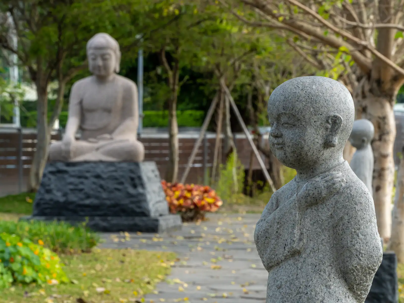 Silent stone sentinels before a serene Buddha.