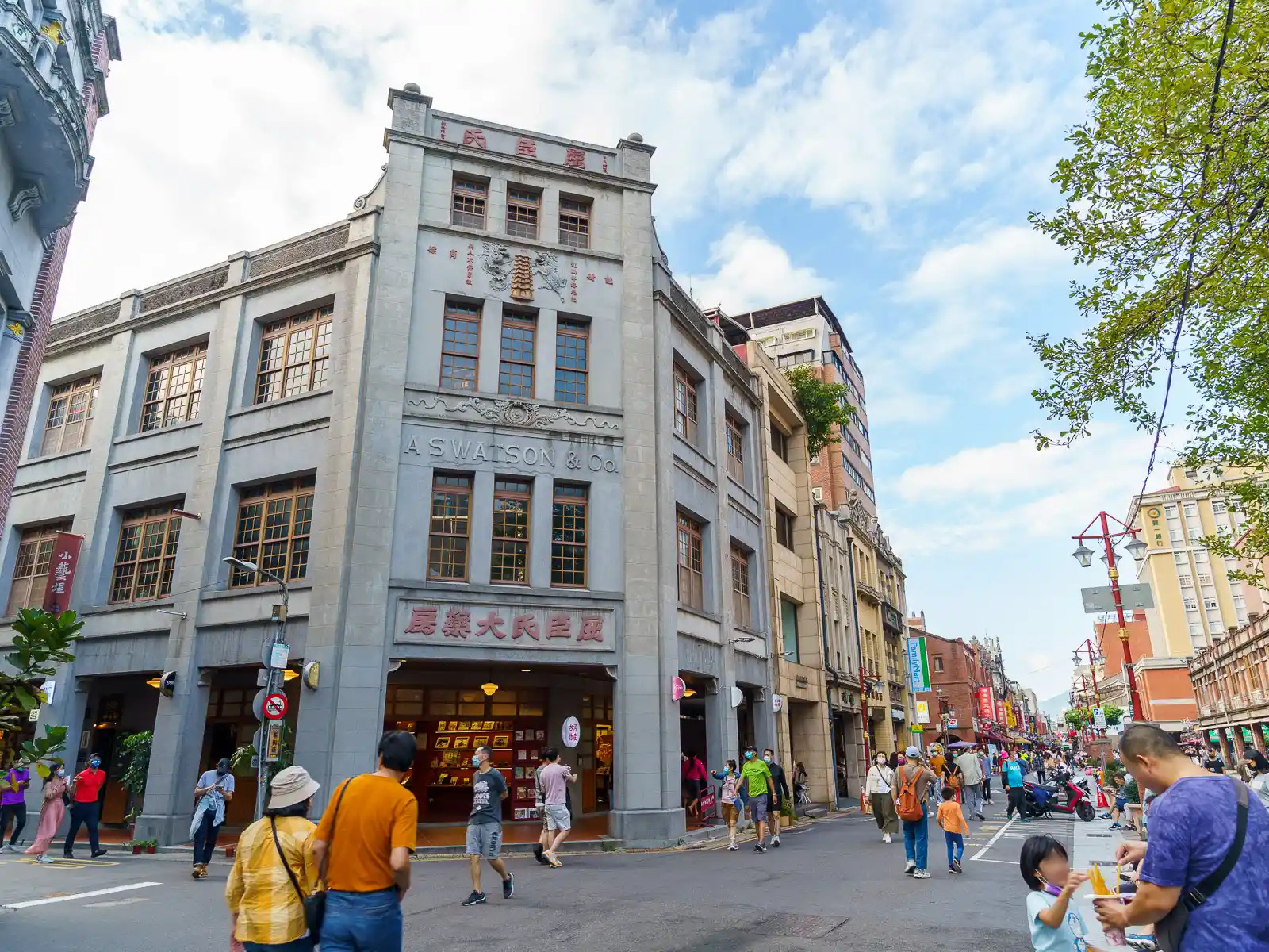 Historic building with "A.S Watson & Co." sign in a bustling street scene.