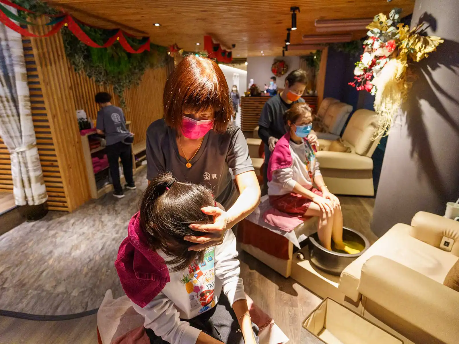 Two clients are receiving massages in a spa.