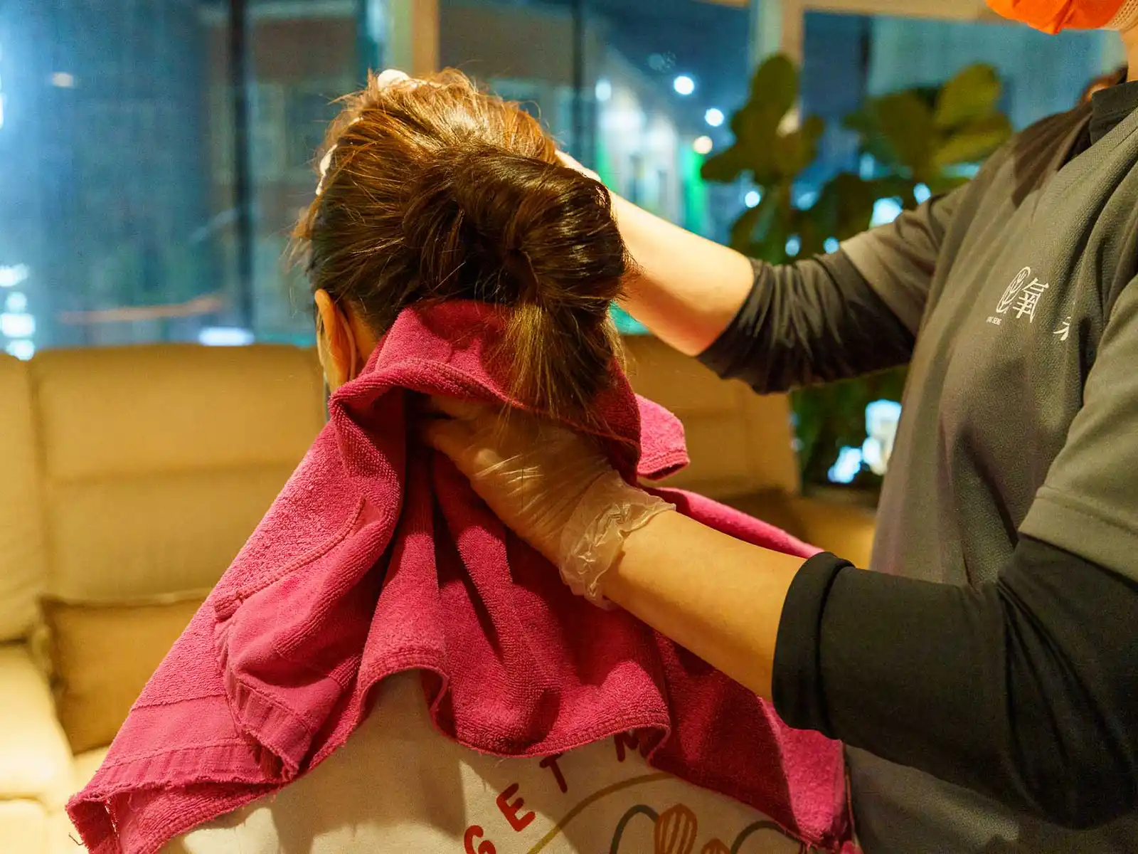 A young client enjoys a relaxing head massage.