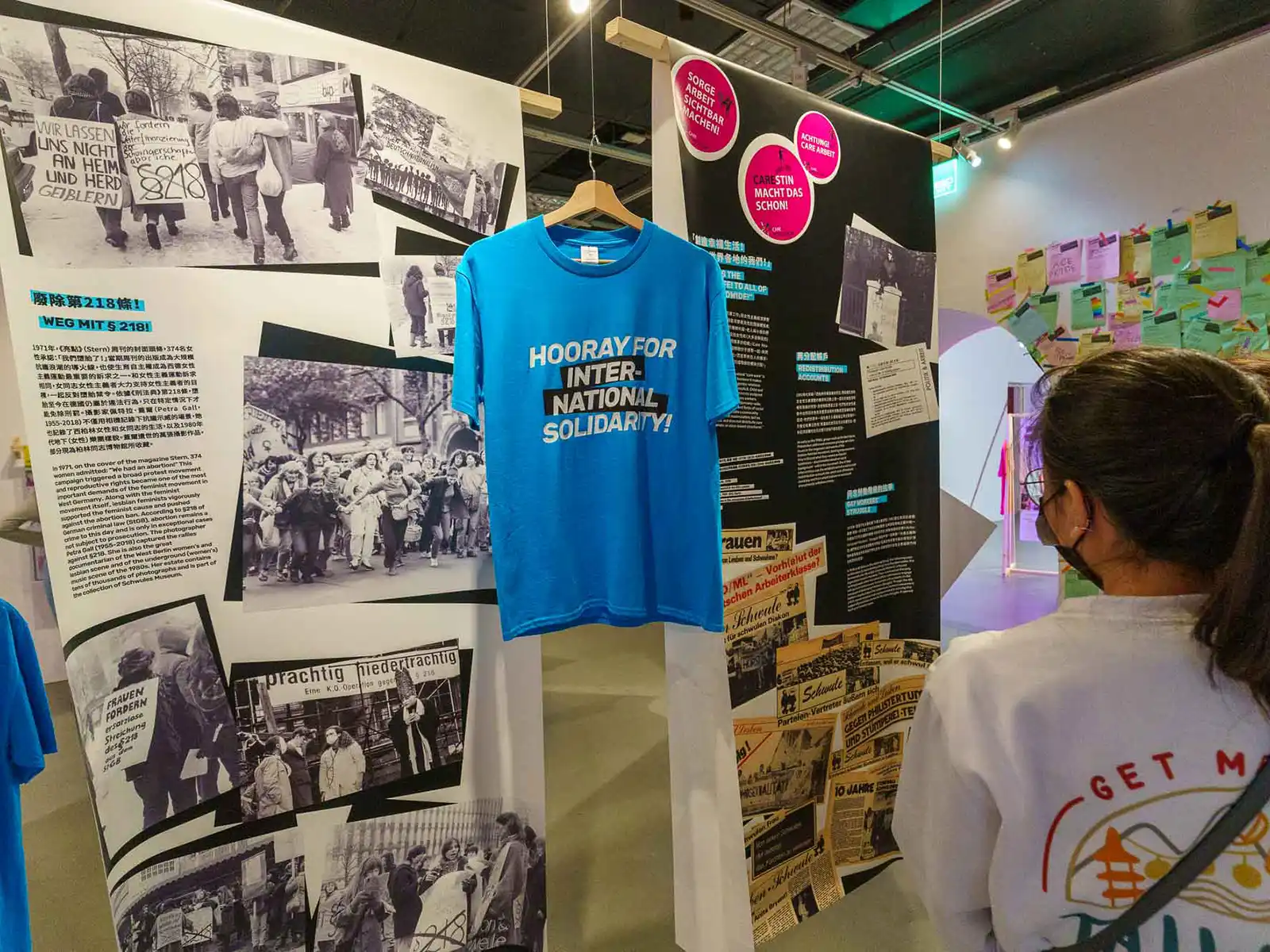 An exhibition on reproductive rights and social movements features newspaper clippings and t-shirts.