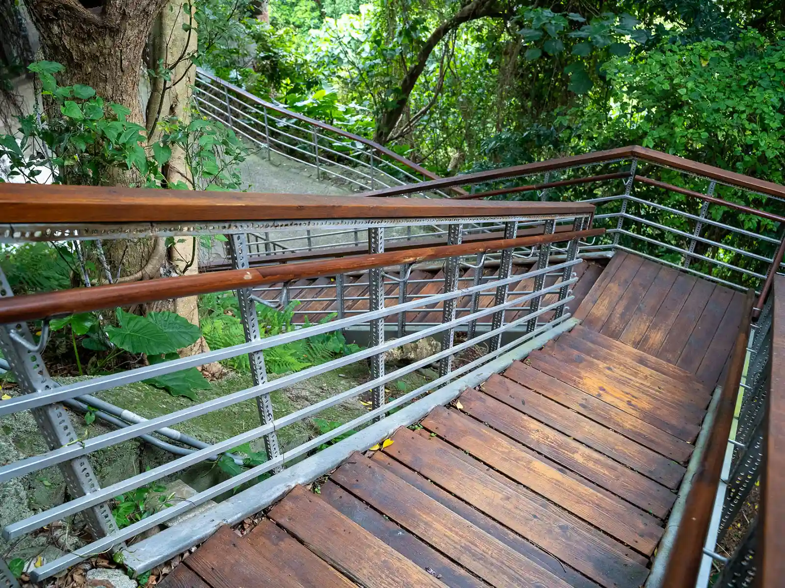 A newly built staircase makes a right angle to connect to an alley below.