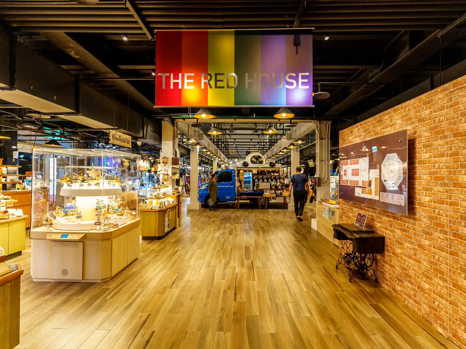 Interior of The Red House with shops and visitors.