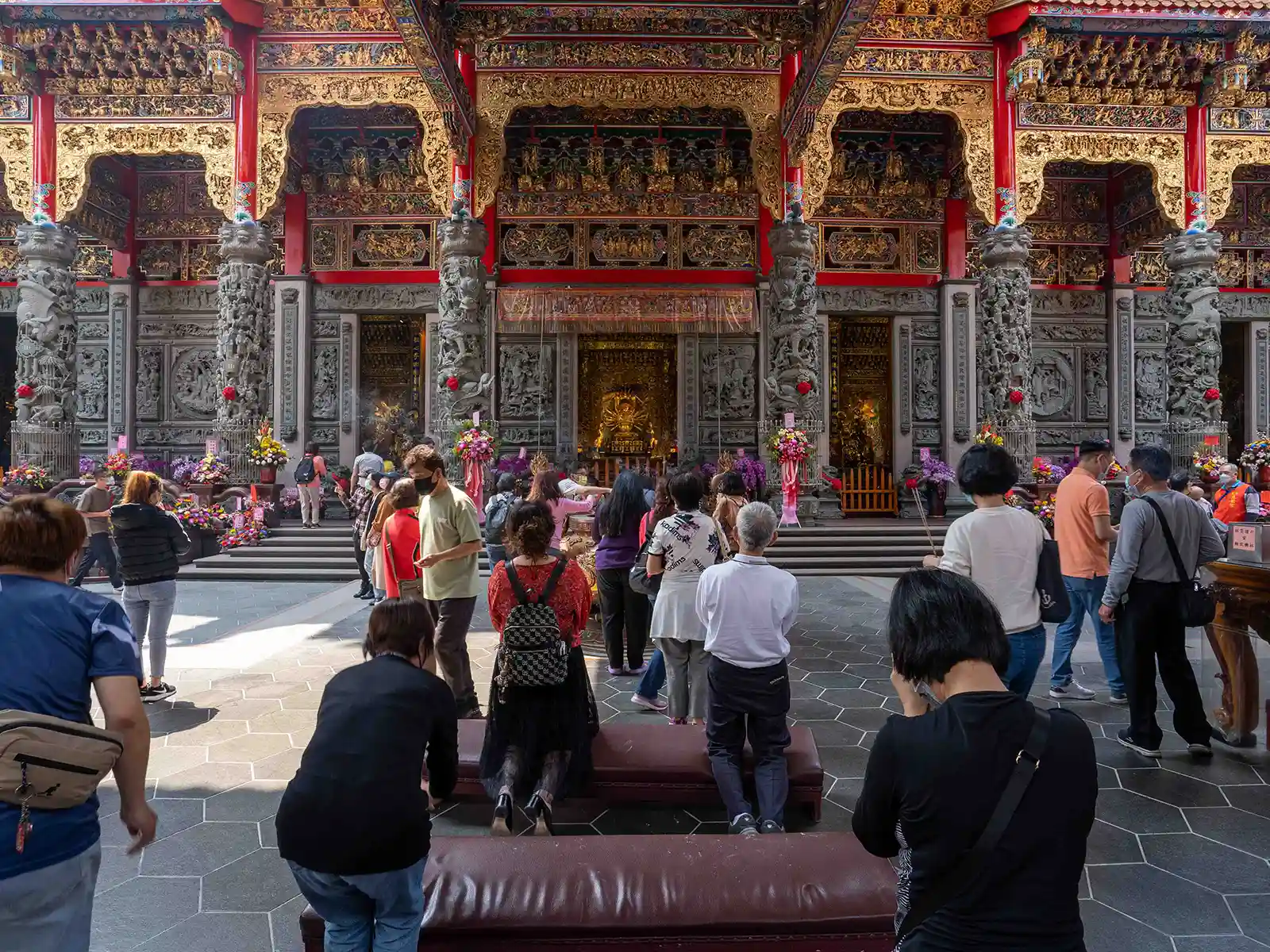 Visitors pray in one of the temples massive main halls.