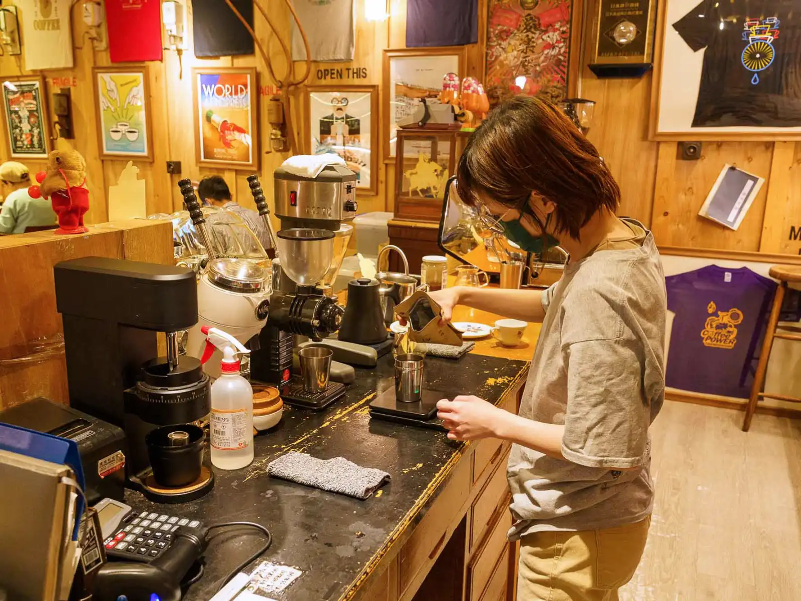 Barista at Debut Cafe in Taipei meticulously preparing a coffee with precision.