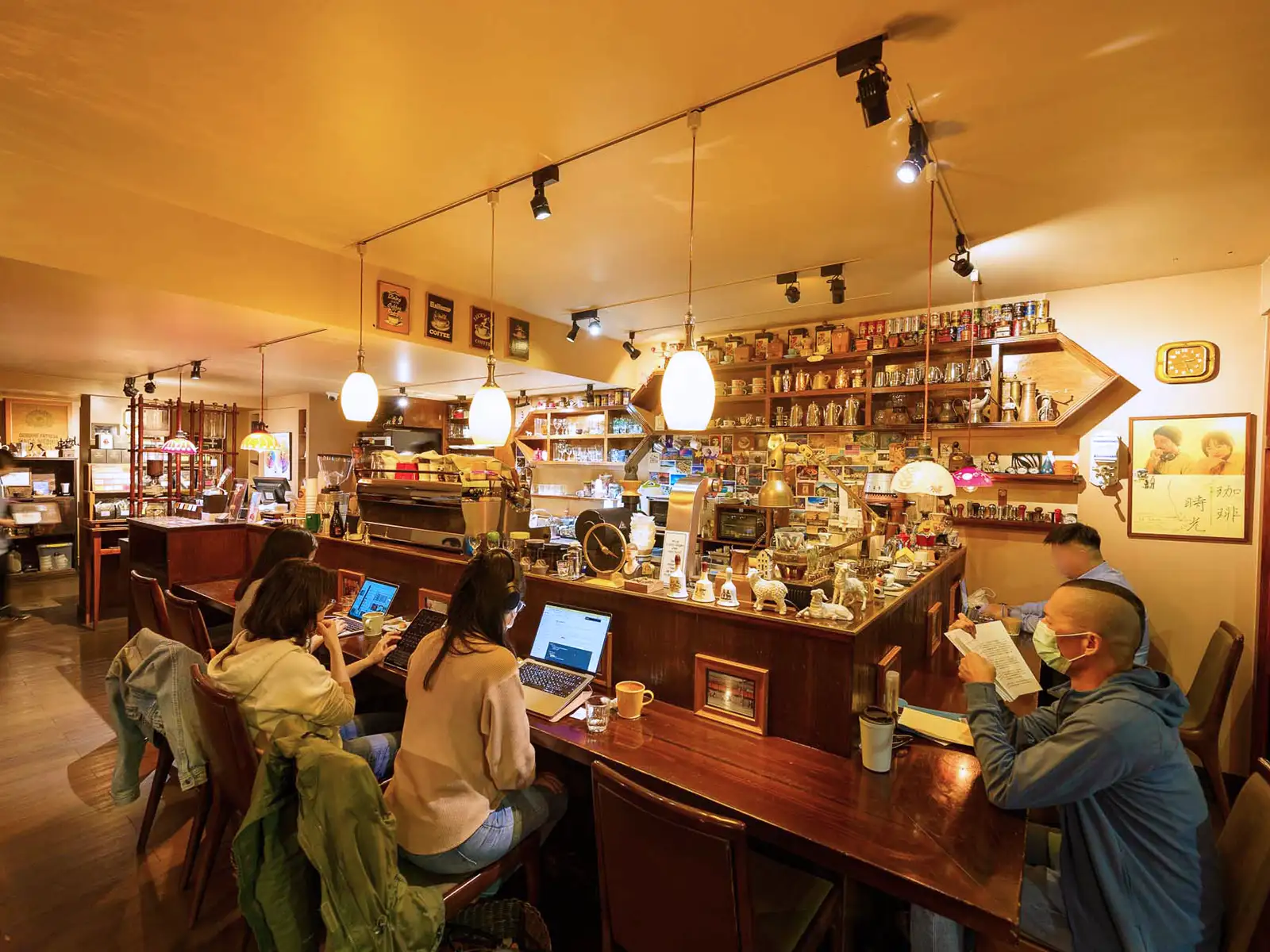 Interior of Rufous Coffee Roasters with customers working on laptops and vintage decor.